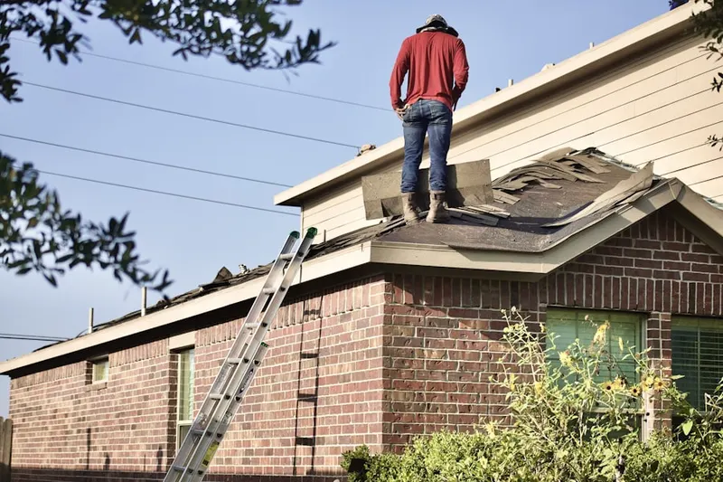 Professional roofer working on a residential roof in North Colebrook